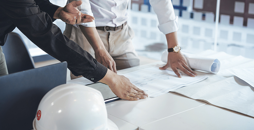 Young asian architect colleagues discussing about construction plans on blueprint and tablet at construction site office. Architect using technology concept. Feasibility studies banner